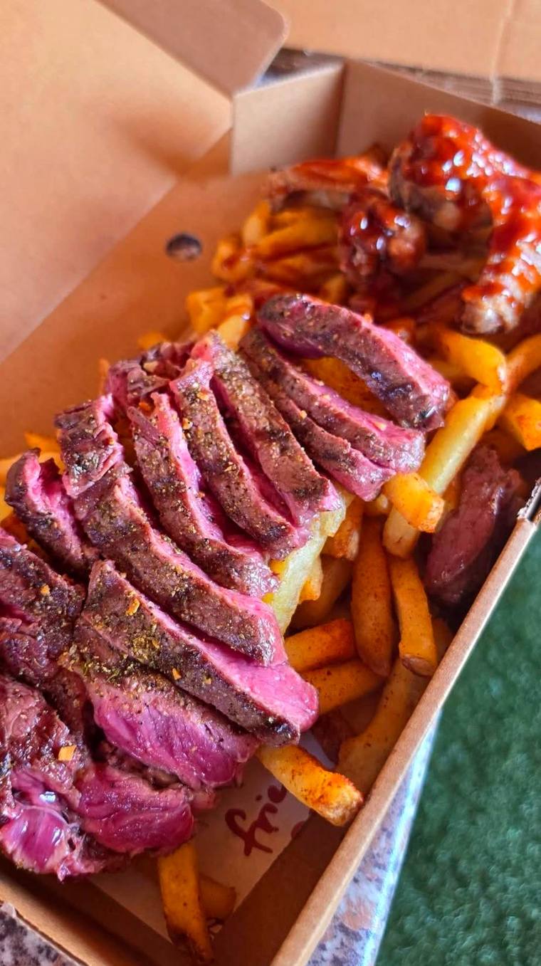 Loaded fries topped with sliced steak