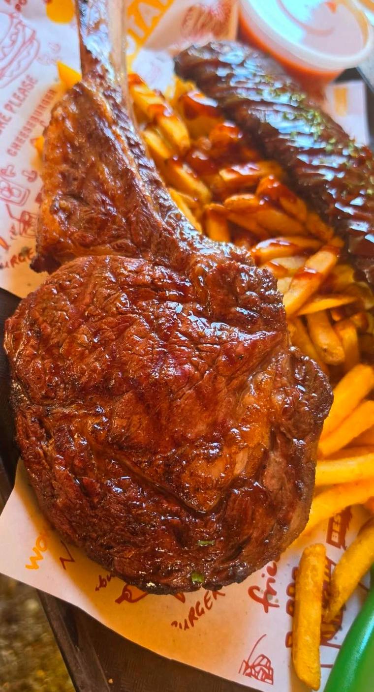 Tomahawk steak plated with fries